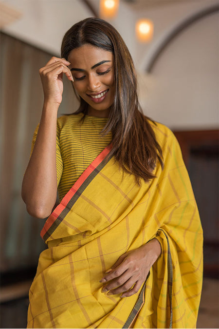 Turmeric yellow saree with chilli flakes and peppercorn dots.